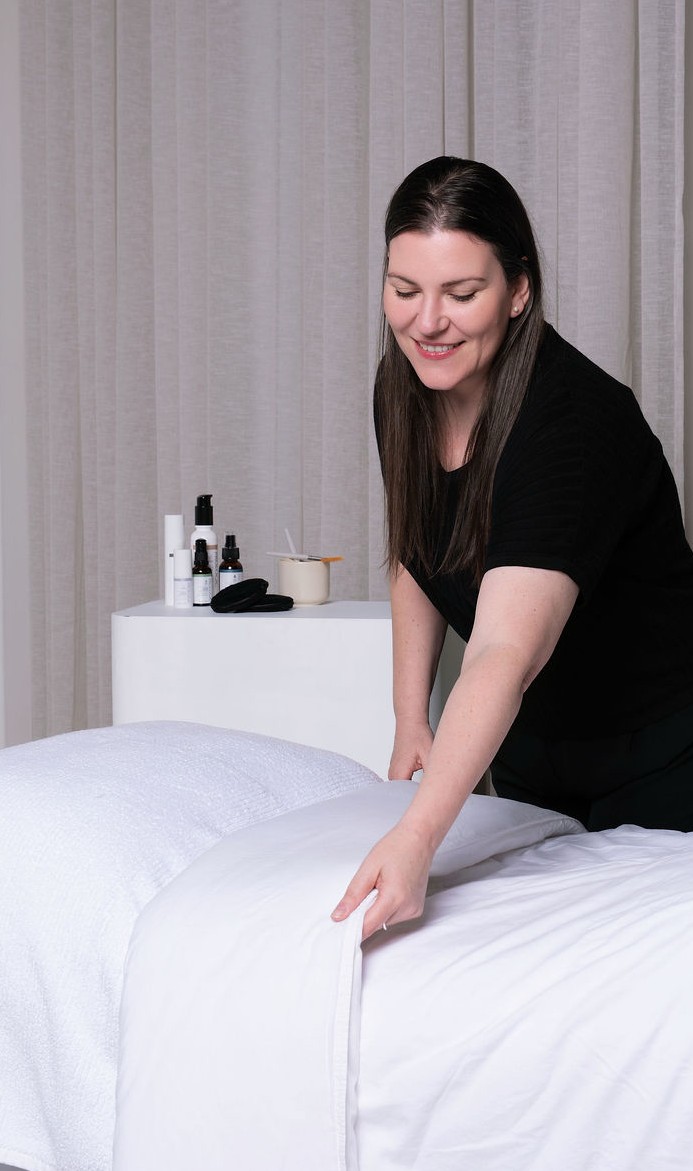 Vanessa preparing the treatment bed at Skin Mantle
